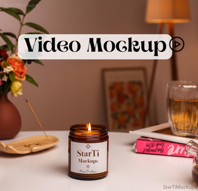 May include: A brown glass candle with a white label that reads "StarTi Mockups Real Product" and a lit wick. The candle is on a white surface with a wooden incense holder and a pink book.