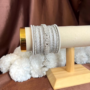 May include: A set of three ceramic nesting bowls in shades of blue, green, and white. The bowls feature a speckled glaze and a simple, modern design. The largest bowl measures approximately 8 inches in diameter.