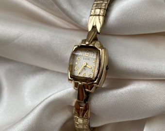 Belle montre vintage minimaliste Elgin en or pour femme