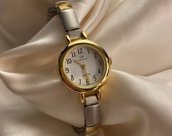 Belle montre analogique vintage dorée et argentée pour femme