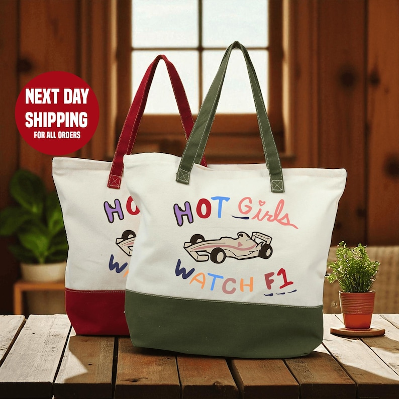 Two colorful tote bags with the text "HOT GIRLS WATCH F1" printed on them, placed on a wooden surface.