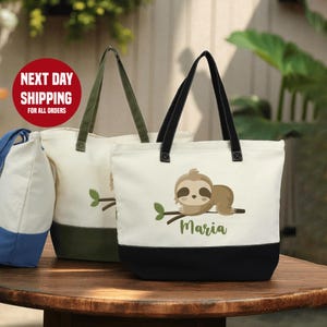 May include: Off-white canvas tote bags with a black or olive green base and matching handles. One bag features a sloth illustration and the name "Maria" in green. The text "NEXT DAY SHIPPING FOR ALL ORDERS" is visible.