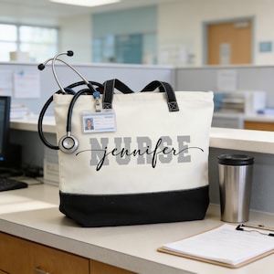 A white tote bag with the name "NURSE" printed on it, along with a stethoscope and a coffee cup, is placed on a desk in an office setting.