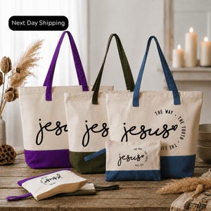 a collection of tote bags and a small bag with the text "The Way Jesus" printed on them, arranged on a wooden surface.