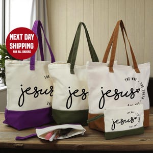 a collection of tote bags and a small bag with the text "The Way - The Truth - Jesus" printed on them, arranged on a wooden surface.