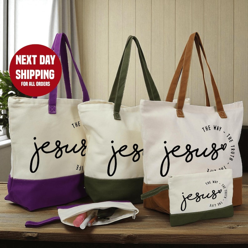a collection of tote bags and a small bag with the text "The Way - The Truth - Jesus" printed on them, arranged on a wooden surface.