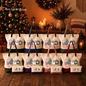 A collection of Christmas-themed tote bags and a small bag is displayed in front of a decorated Christmas tree, with a wreath and candles in the background.