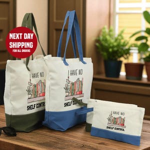 a set of three tote bags and a small bag with the text "I HAVE NO SHELF CONTROL" printed on them, placed on a wooden surface.
