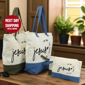 a set of three tote bags with the text "The Way" printed on them, along with a small bag and a plant in the background.