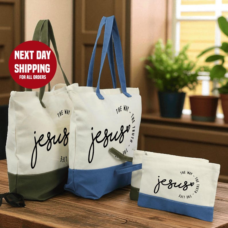 a set of three tote bags with the text "The Way" printed on them, along with a small bag and a plant in the background.