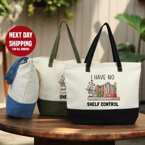 two tote bags with printed designs, one white and one green, placed on a wooden table.