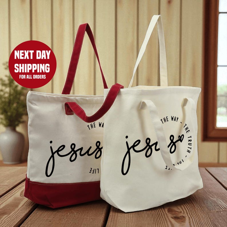 Two tote bags with the text "The Way Jesus" printed on them, placed on a wooden surface.