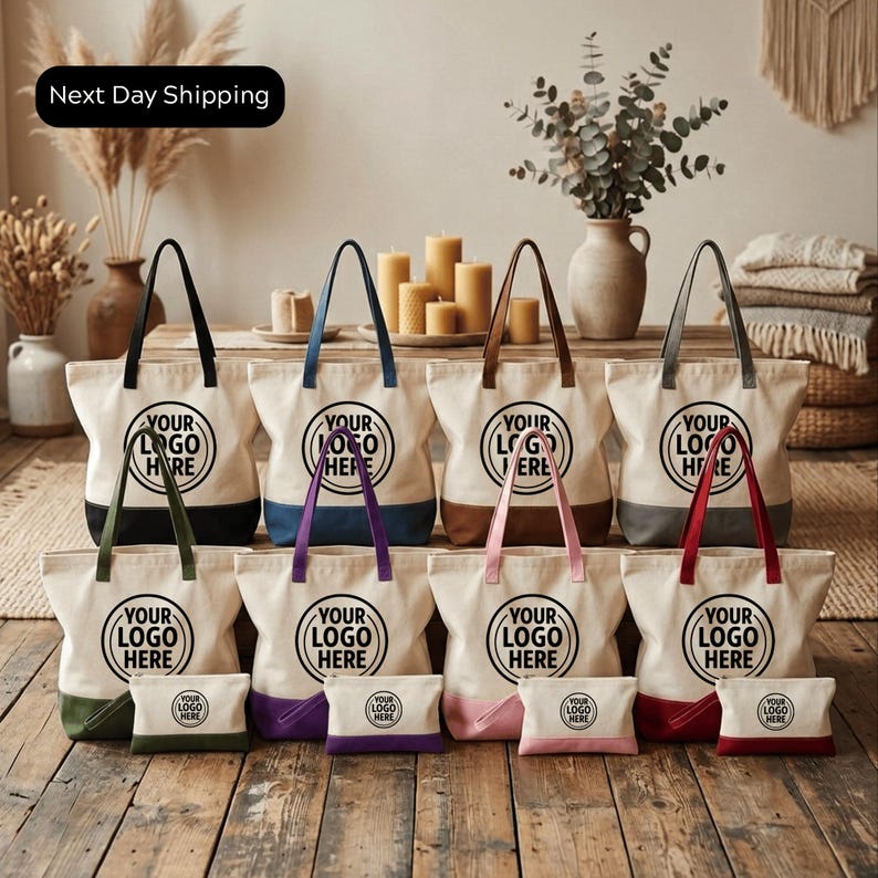 A collection of white tote bags with the text "YOUR LOGO HERE" printed on them, displayed on a wooden floor.