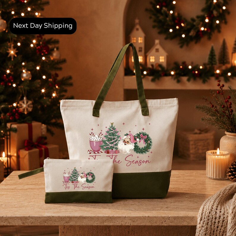 A white tote bag with a festive design and the text "The Season" printed on it, placed on a wooden surface. In the background, there is a Christmas tree and other holiday decorations, creating a cozy and festive atmosphere.