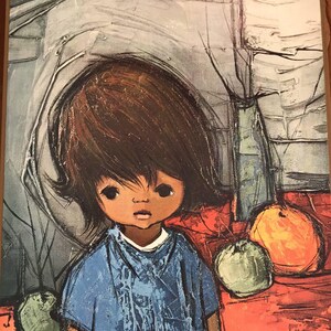 May include: An original painting featuring a child with large eyes and brown hair wearing a blue shirt. The artwork includes still life elements like fruit and a vase, set against a red and gray background. Signed "Hoertman".