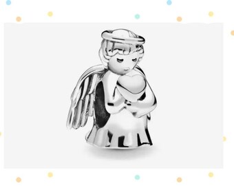 May include: A silver charm in the shape of an angel holding a heart. The angel has wings and a halo.