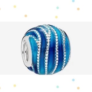 May include: A blue and silver charm bead with a swirling pattern. The bead is round and has a shiny finish.