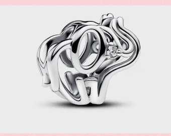 May include: A silver charm with a stylized heart design featuring the word "love" in a script font. A small clear crystal is set in the center of the heart.