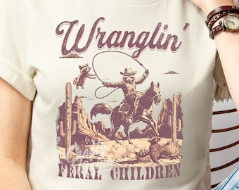 Wranglin Feral Kids PNG File, Funny Western Png, Funny Mom Png, Feral Png, Funny Png, Feral Shirt Png, Western Raccoon Png, Funny Mom Quote