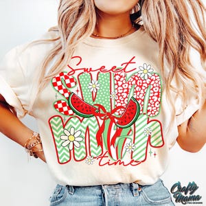 May include: A white t-shirt with a graphic design that says "Sweet Summer Time" in red, green, and white. The design features watermelon slices, daisies, and checkered patterns.