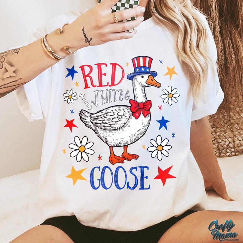 May include: White t-shirt with a red, white, and blue goose wearing a red, white, and blue hat. The text "Red White & Goose" is printed on the shirt.