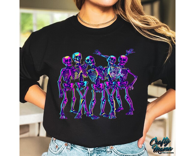 May include: A black sweatshirt with a graphic of five skeletons in neon colors dancing. The skeletons are wearing a variety of poses and expressions.