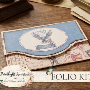 May include: A folio kit with a blue and cream design. The kit features a patriotic eagle emblem with the text "USA 1776-2026". The kit has a vintage aesthetic with a floral and butterfly design.