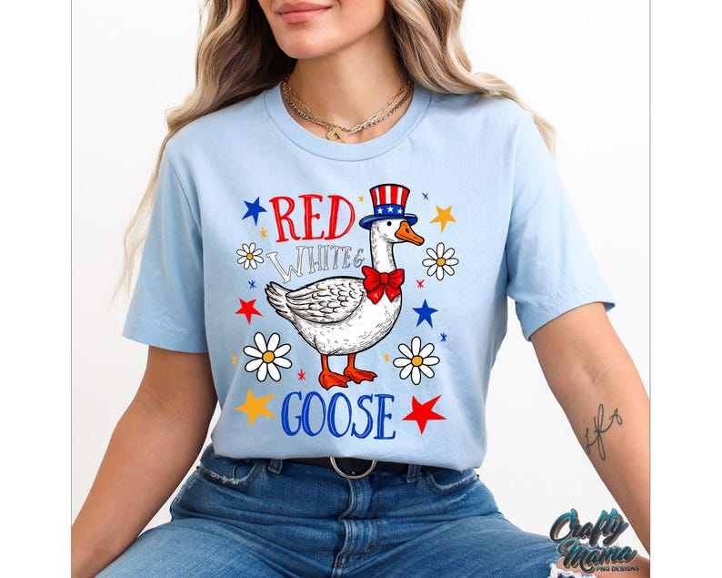 May include: A light blue t-shirt with a red, white, and blue goose wearing a red, white, and blue hat and a red bow tie. The text "Red White & Goose" is printed on the shirt.