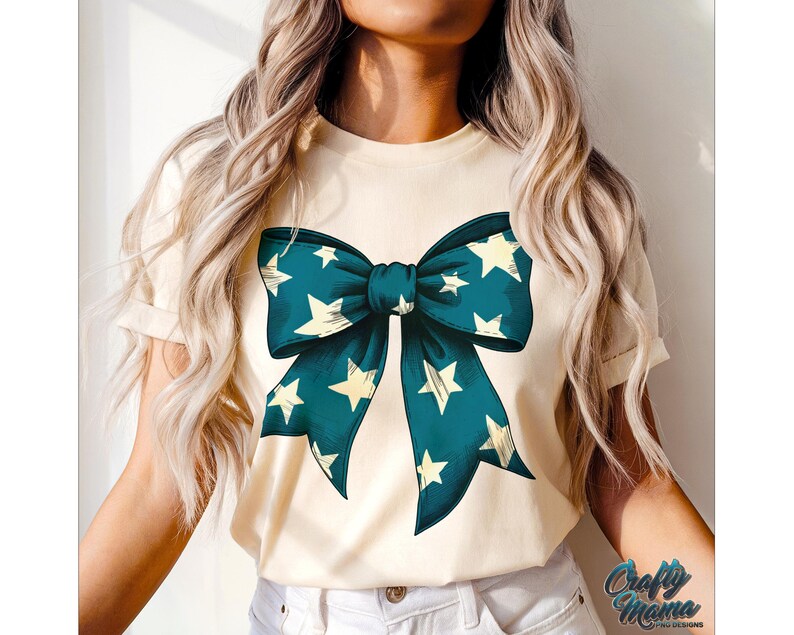 May include: A white t-shirt with a blue and white bow with stars printed on it.