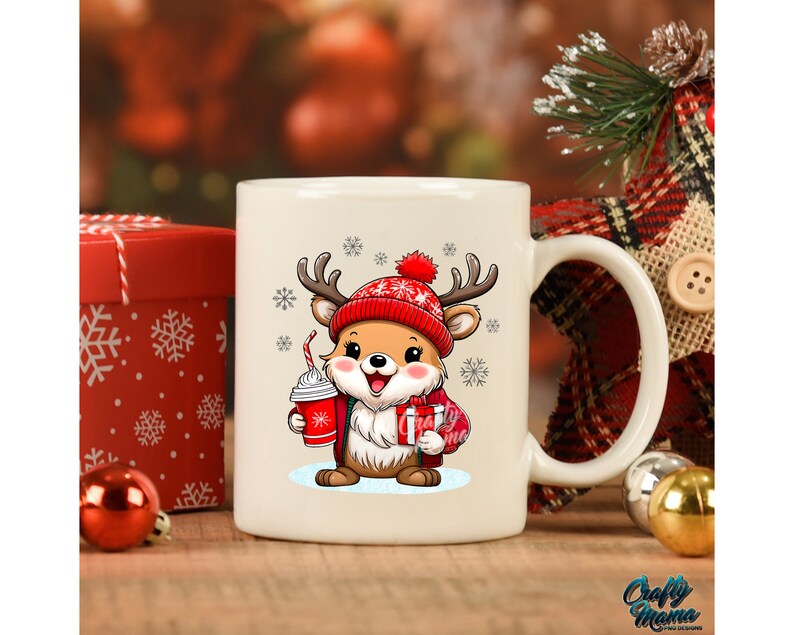 May include: White ceramic mug with a cartoon reindeer wearing a red hat and holding a red cup. The reindeer is surrounded by snowflakes.