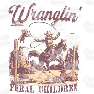 May include: A distressed graphic tee design featuring a raccoon cowboy riding a horse and roping another raccoon. The text "Wranglin' Feral Children" is arched above and below the image. The color palette includes shades of brown, tan, and purple.