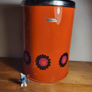 Retro tin, storage container, 1960s. Brabantia metal tin with lid in orange.
