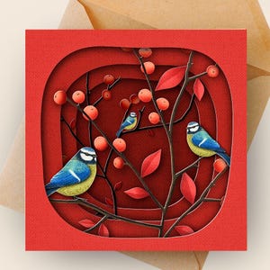 May include: A square red greeting card with a layered design featuring blue and yellow birds perched on branches with red berries and leaves. The card is set against a brown envelope.