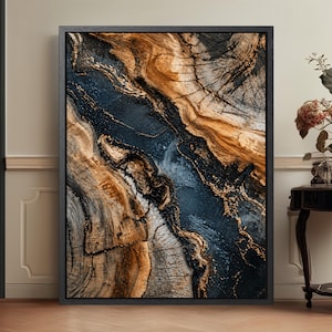 May include: Abstract framed art print showing a close-up of a tree trunk's cross-section. The artwork features brown, grey, and navy blue tones with gold accents. The wood grain pattern is prominent, creating a textured appearance.