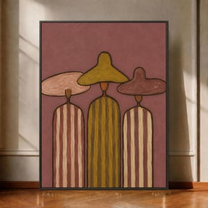 May include: A framed painting on a mauve background featuring three figures wearing wide-brimmed hats. The outer two figures wear striped garments in mauve and cream, while the central figure wears a solid olive green garment with vertical lines.