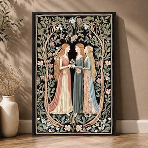May include: A rectangular framed wall art print featuring three figures with long hair in flowing dresses standing together. They are surrounded by an intricate, symmetrical border of intertwining branches, green leaves, and pink and white flowers on a black background.