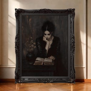 May include: A framed painting of a woman in a black dress reading a book. The painting is in a black ornate frame. A vase of dried flowers sits on a table next to the woman. The background is dark.