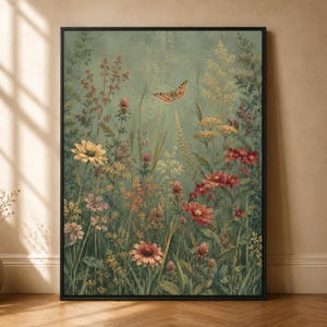May include: A framed wall art print featuring a botanical scene with a sage green background. The artwork displays a variety of wildflowers in shades of yellow, red, and pink, interspersed with tall grasses and a single butterfly in flight.