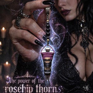 May include: A gothic-style pendant amulet. The amulet is cylindrical, wrapped in purple and black twine, and has a silver-coloured cap. The text "The power of the rosehip thorns in an amulet" is visible at the bottom of the image.