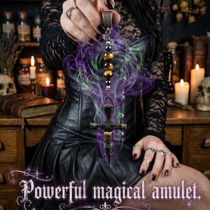 May include: Amulet with a cross-shaped pendant, featuring tiger's eye beads and a decorative metal top. The image includes the text "Powerful magical amulet."