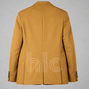 May include: Mustard-colored blazer with a classic design. The back view shows a tailored fit, notched lapels, and buttoned cuffs. The blazer has a two-button closure and a vent at the back. The image also shows the text "hlc" in a vertical pattern.