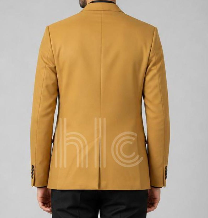 May include: Mustard yellow blazer with a two-button closure and black buttons. The back of the blazer is visible, showing a tailored fit and a vent at the bottom. The blazer has a classic, formal style.