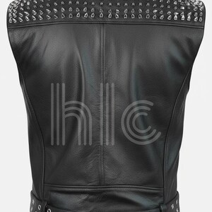 May include: Black leather vest with silver cone studs on the shoulders. The vest has a belt with silver grommets at the waist. The back of the vest is visible, showing the stitching and design.
