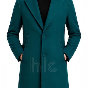 May include: A teal overcoat with a classic design. The coat features a notched lapel, two front pockets, and a two-button closure. The coat is a solid color and has a tailored fit. The text "hlc" is visible on the coat.