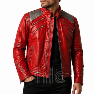 May include: A bright red leather jacket with silver zips and studded shoulder detailing. The jacket has multiple zipped pockets and a stand-up collar. The design is a classic biker style, suitable for various occasions.