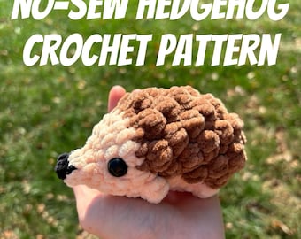 May include: A brown and pink crocheted hedgehog with black eyes. The hedgehog is being held in a hand. The image has the text "NO-SEW  HEDGEHOG CROCHET PATTERN" at the top.