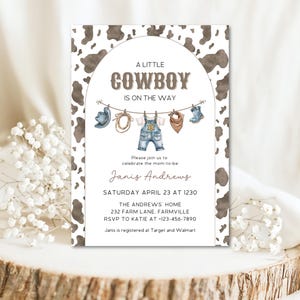 May include: A baby shower invitation with a cowboy theme. The invitation features a cowhide pattern background and watercolor illustrations of cowboy attire. Text reads "A Little Cowboy Is On The Way."