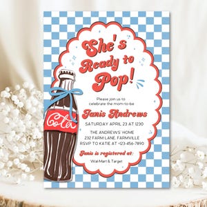 May include: Invitation with a retro design featuring a brown soda bottle with a blue bow and the word "Cola." The invitation reads "She's Ready to Pop!" and includes event details for Janis Andrews.