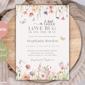 May include: A baby shower invitation with floral and butterfly illustrations. The invitation reads "a little LOVE BUG IS ON THE WAY" and includes details for Stephanie Bordon's baby shower. The design features watercolor flowers and butterflies.