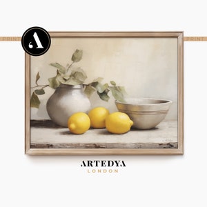 May include: A still life painting of a white ceramic pitcher with a leafy branch, three yellow lemons, and a white ceramic bowl on a wooden table.